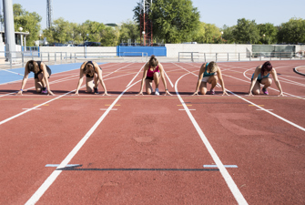 Athletes in starting position on running track